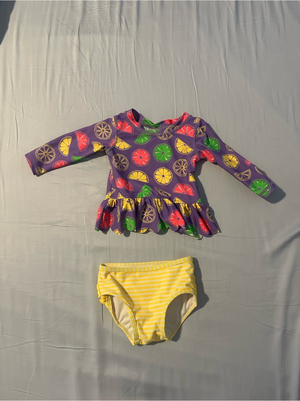 Ruffle Butts Purple Citrus Ruffle Rashguard with Yellow Stripe Bottom